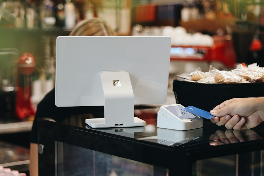 Customer paying by card at a shop checkout counter