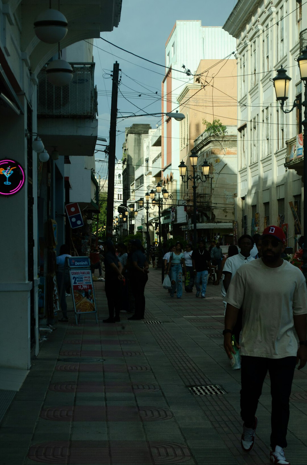 Shopping street with bright storefronts and passers-by